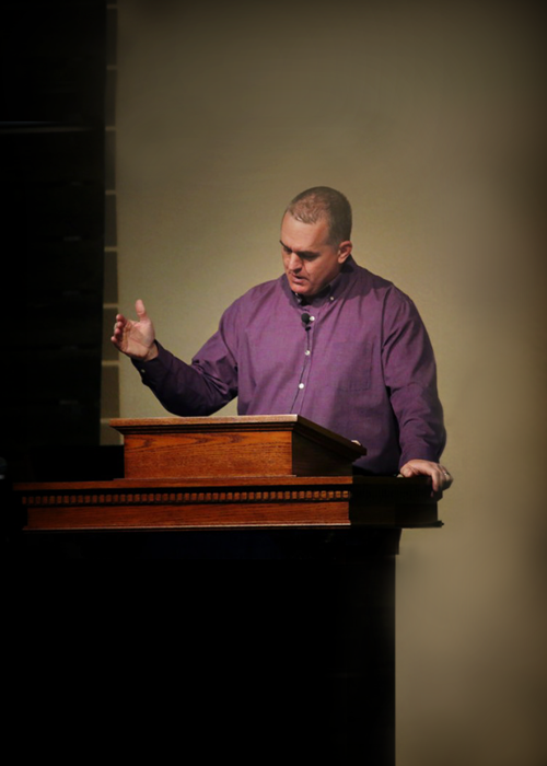Pastor Jon preaching from the pulpit